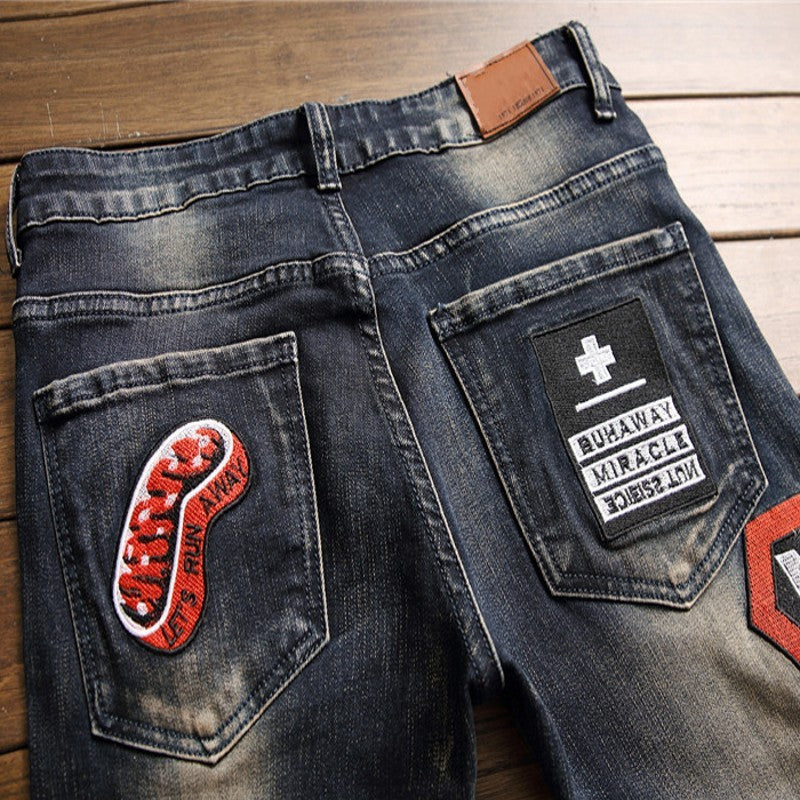 Jeans rasgados Vaqueros con parche de insignia para hombre